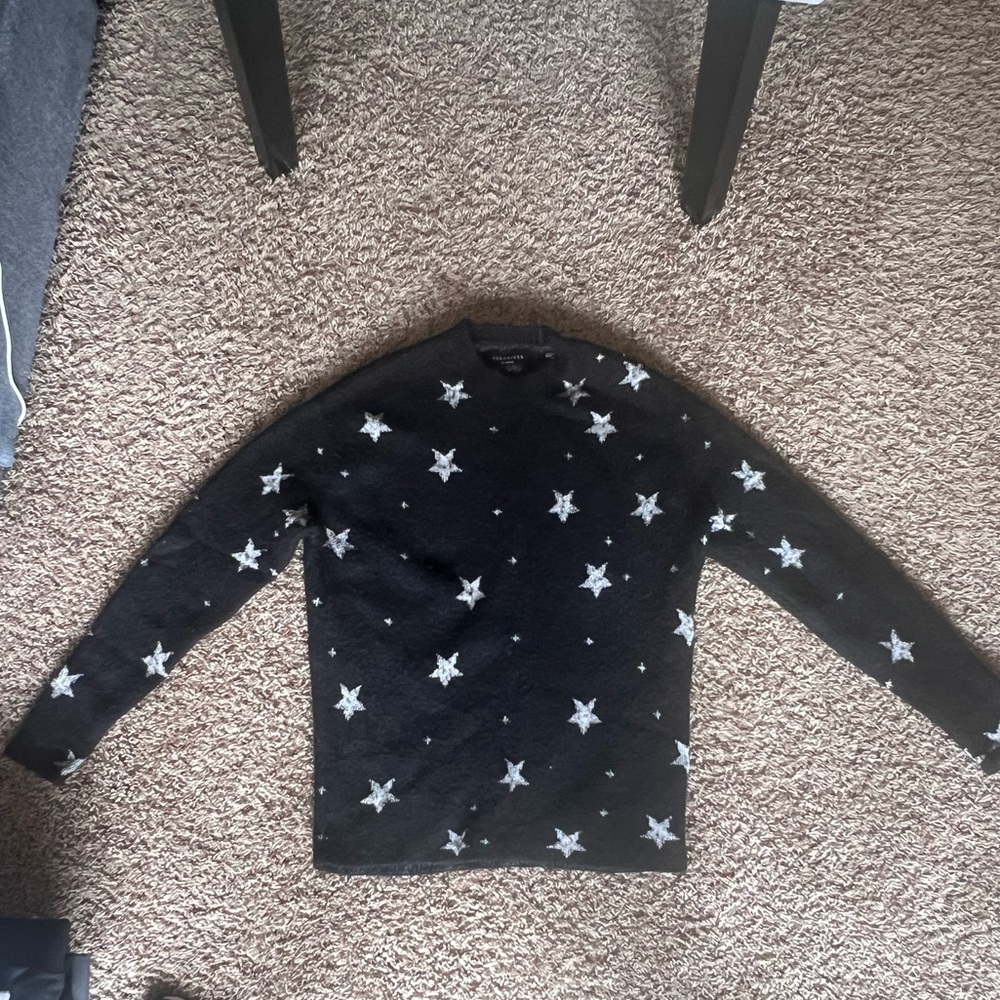 AllSaints black with white stars sweater.